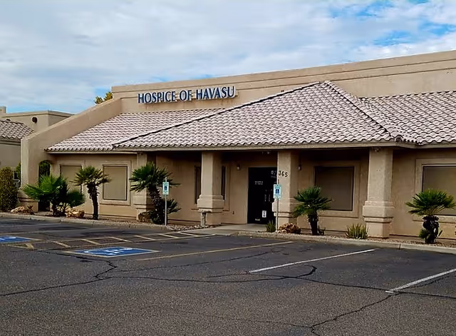 Exterior view of a beige Hospice of Havasu building with a tiled roof.