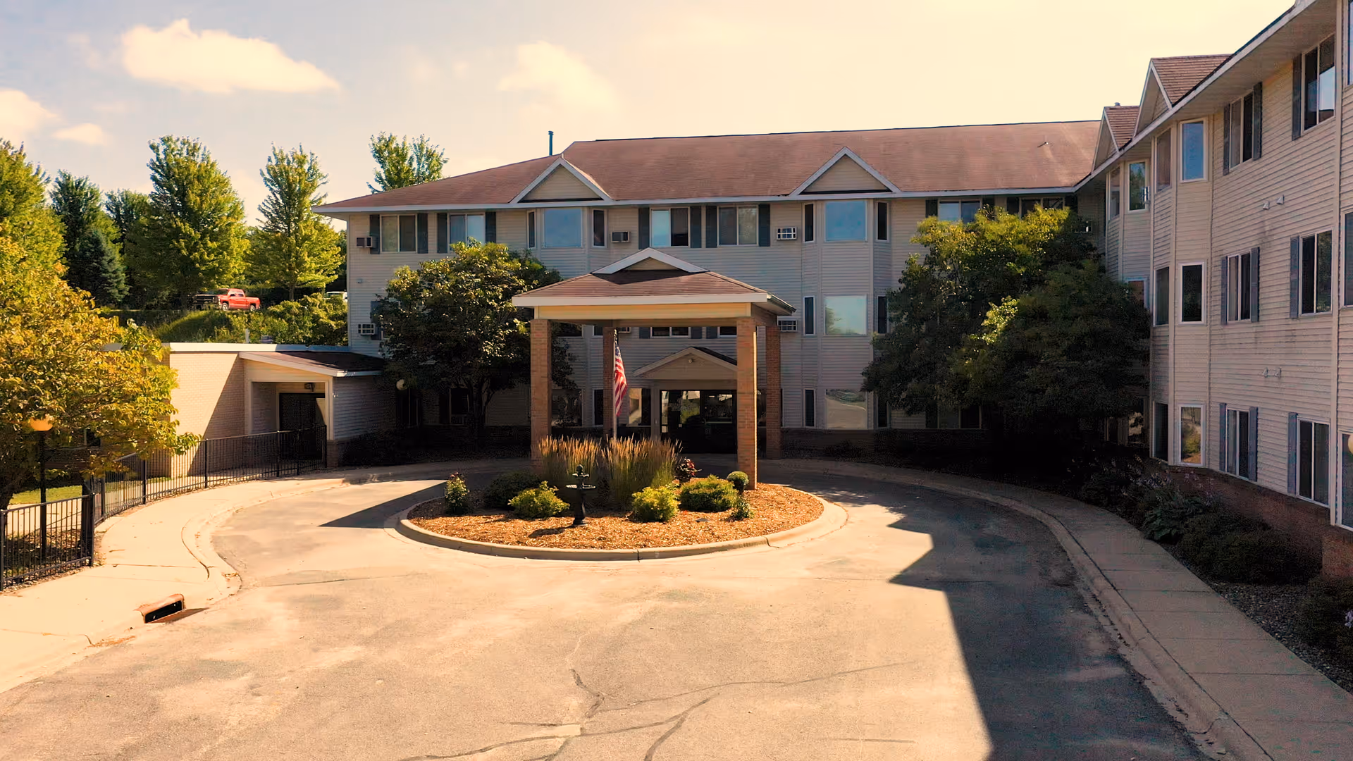 Exterior view of Pleasant View Estates, a multi-story senior living facility with a circular driveway.