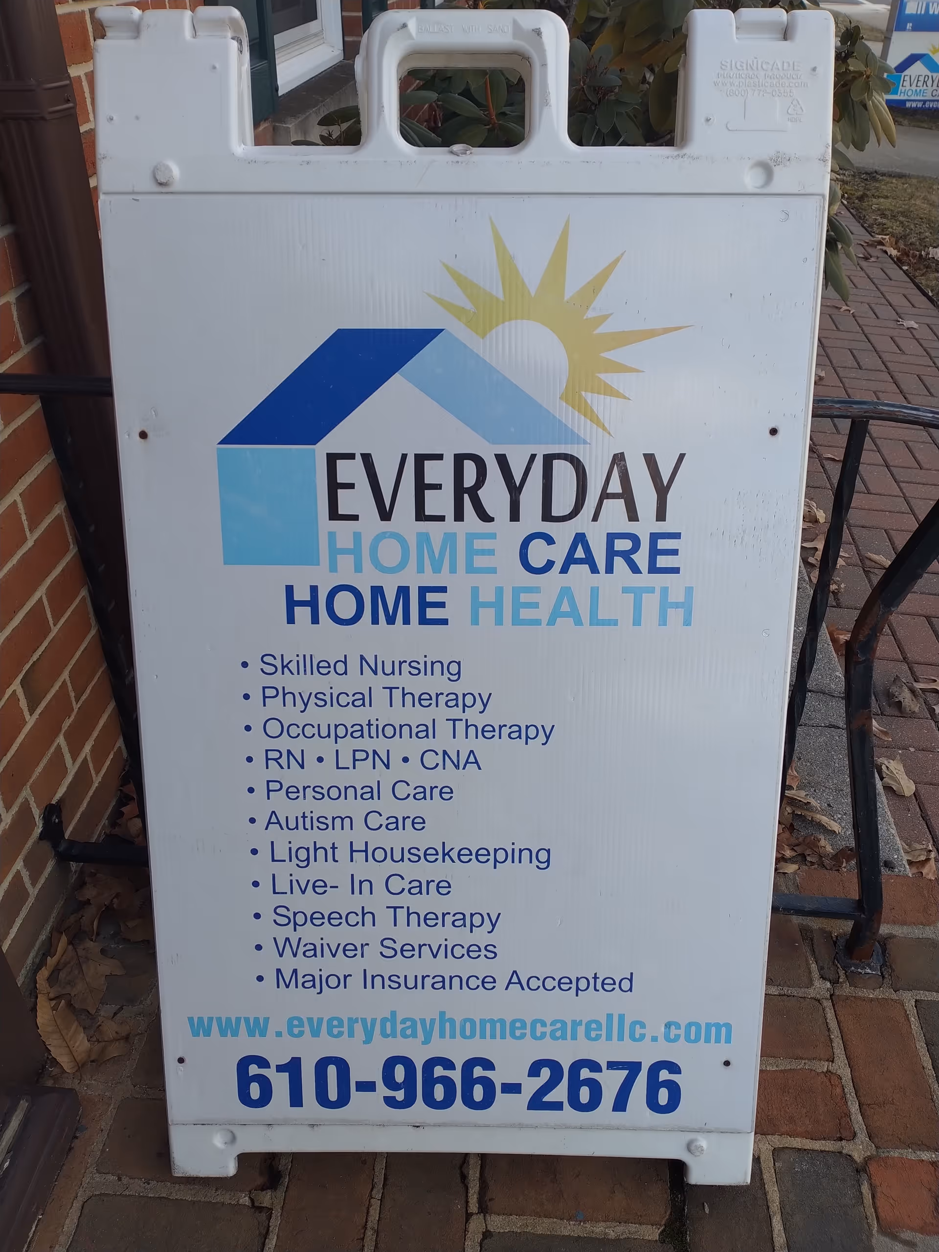 Outdoor sidewalk sign advertising Everyday Home Care and Home Health services outside a brick building.