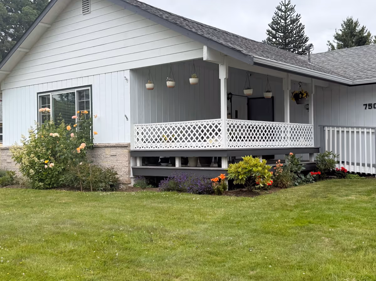 Front exterior of a single-story house with a covered porch and garden.