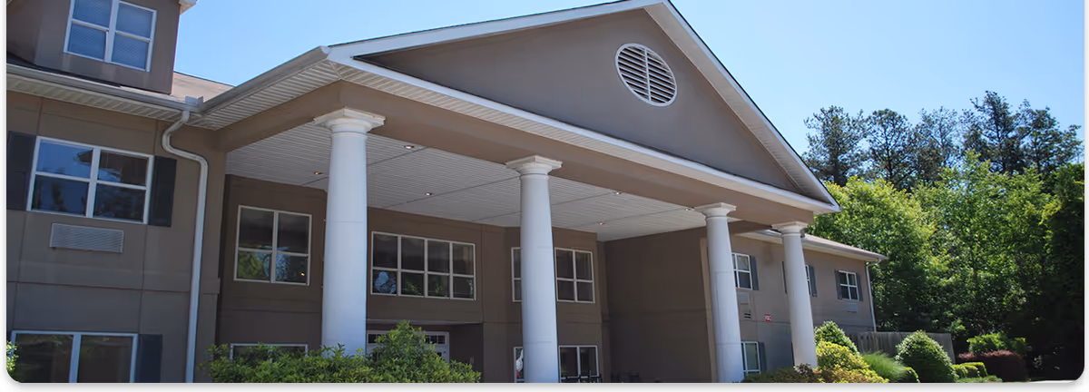 Front view of Summerset senior living building with white columns and landscaping