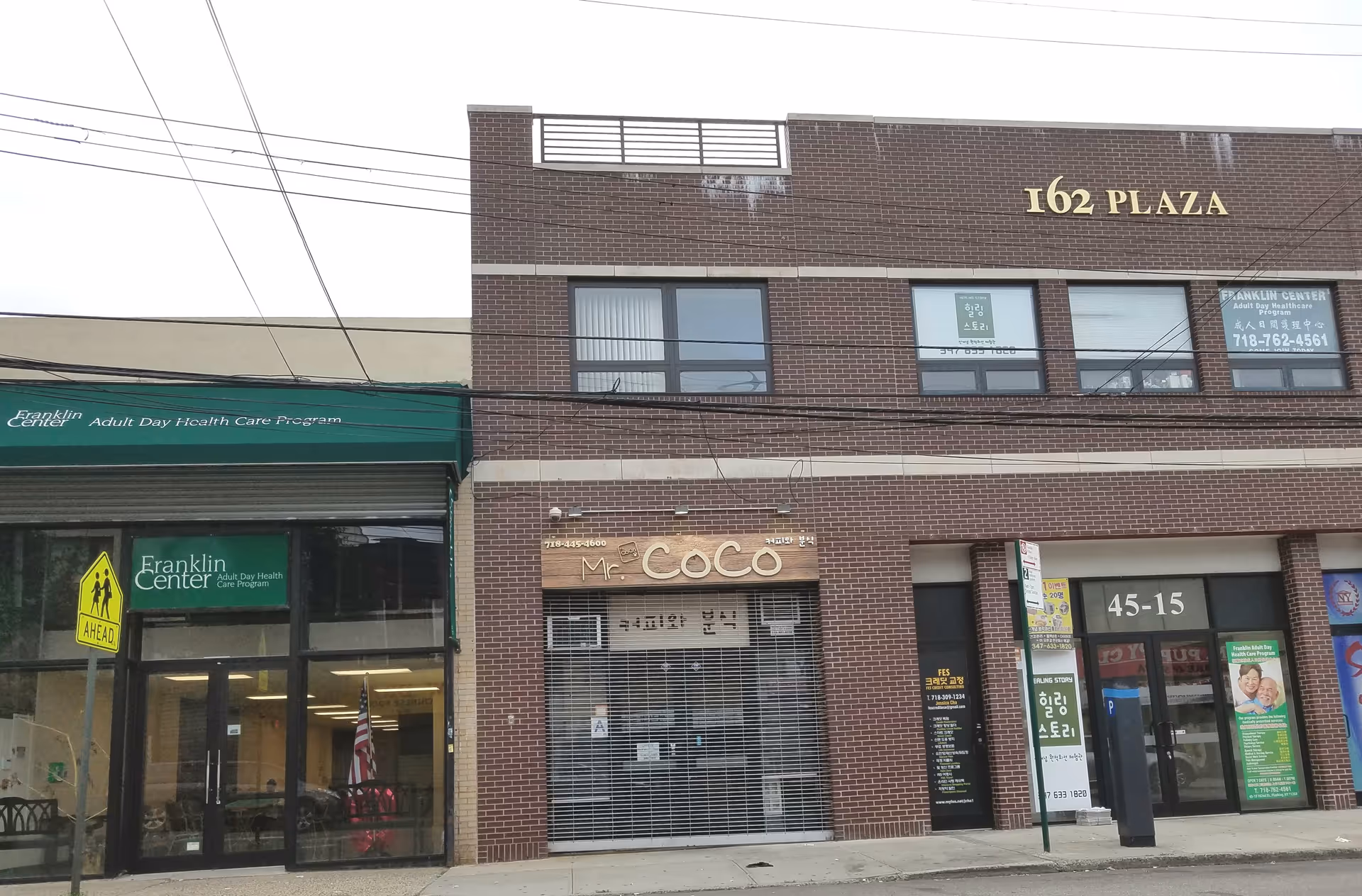 Brick building with storefronts along a city street, including a Franklin Adult Day Health Care sign.