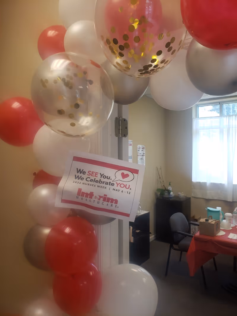 Interior celebration area with balloons and a Nurses Week sign for Interim HealthCare.