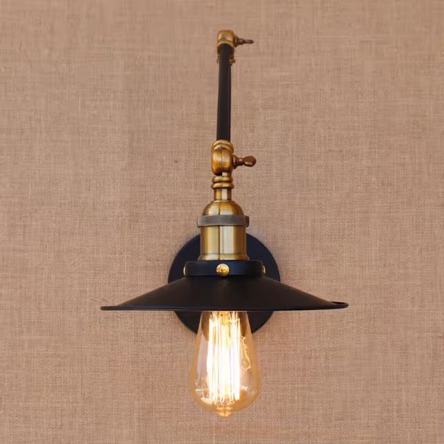 Vintage brass wall lamp with an exposed filament bulb on beige textured wall.
