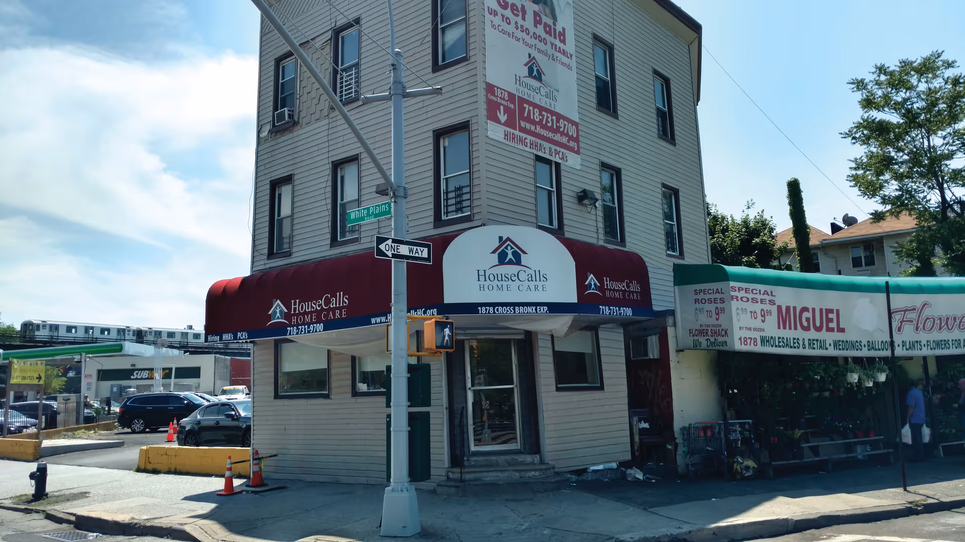 Corner building facade with HouseCalls Home Care signage and red awnings.