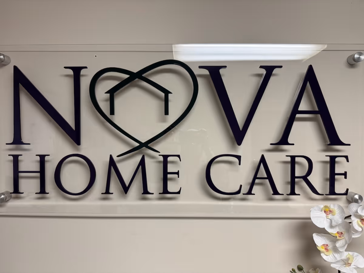 An indoor wall sign displaying NOVA HOME CARE and a heart-shaped logo.