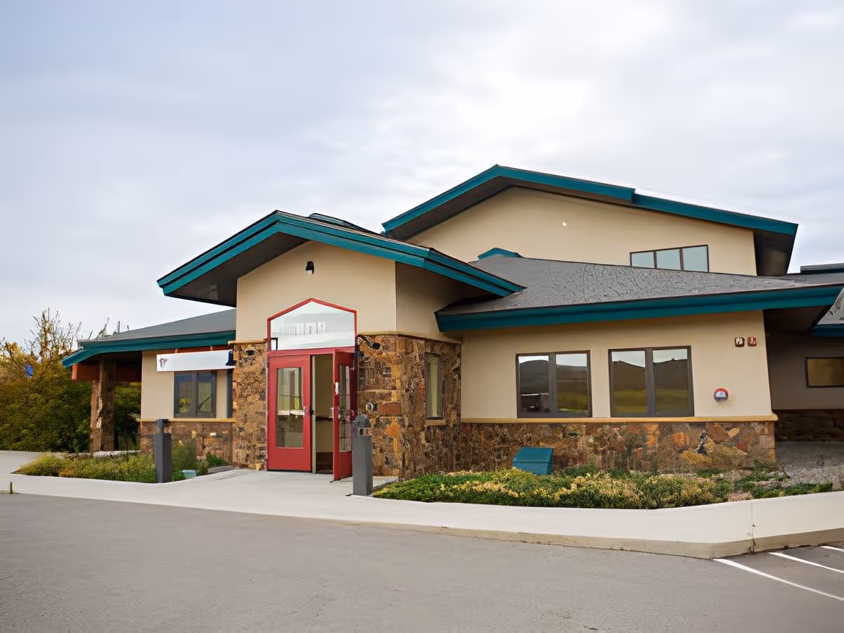 The Haven senior living facility exterior with stone accents and red entrance doors.