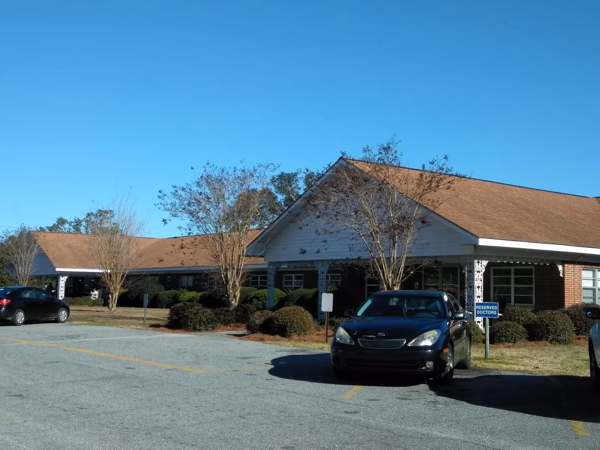Front view of a single-story brick senior living facility with a brown roof.