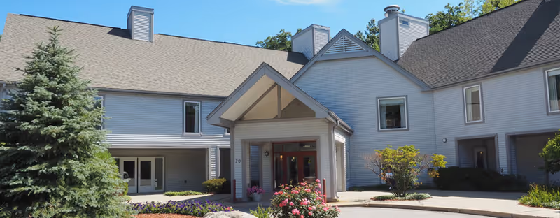Exterior view of Briarwood Community building with a covered entrance and landscaped walkway.