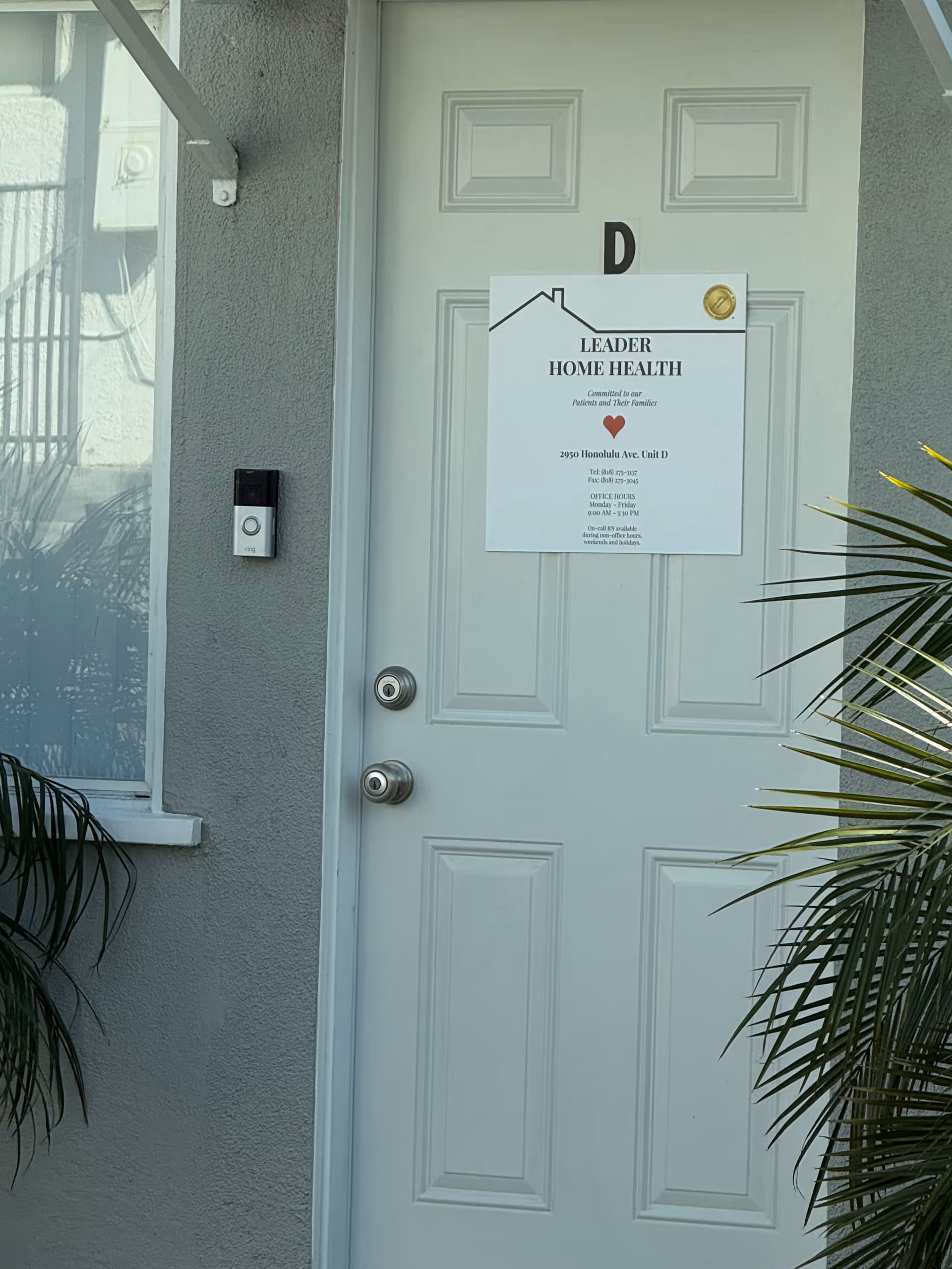 White front door with Leader Home Health sign on exterior entry