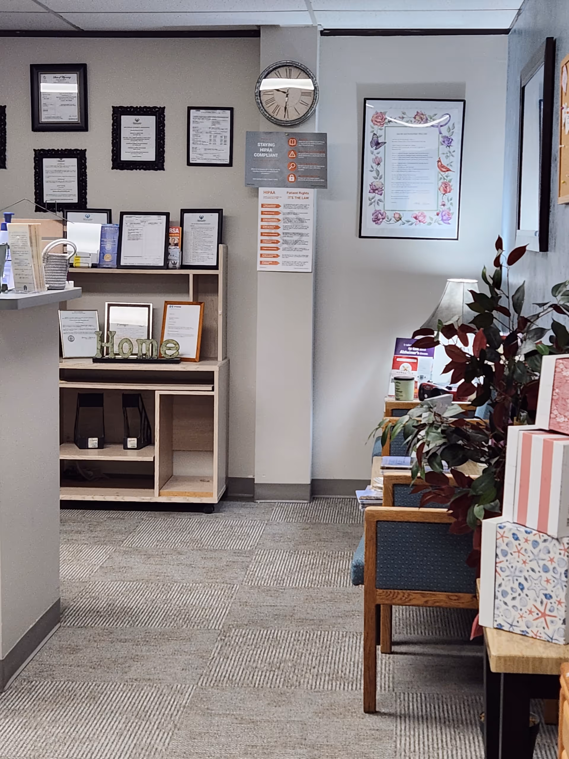 Reception area of Intermountain Home Health with wall certificates, clock, and seating.