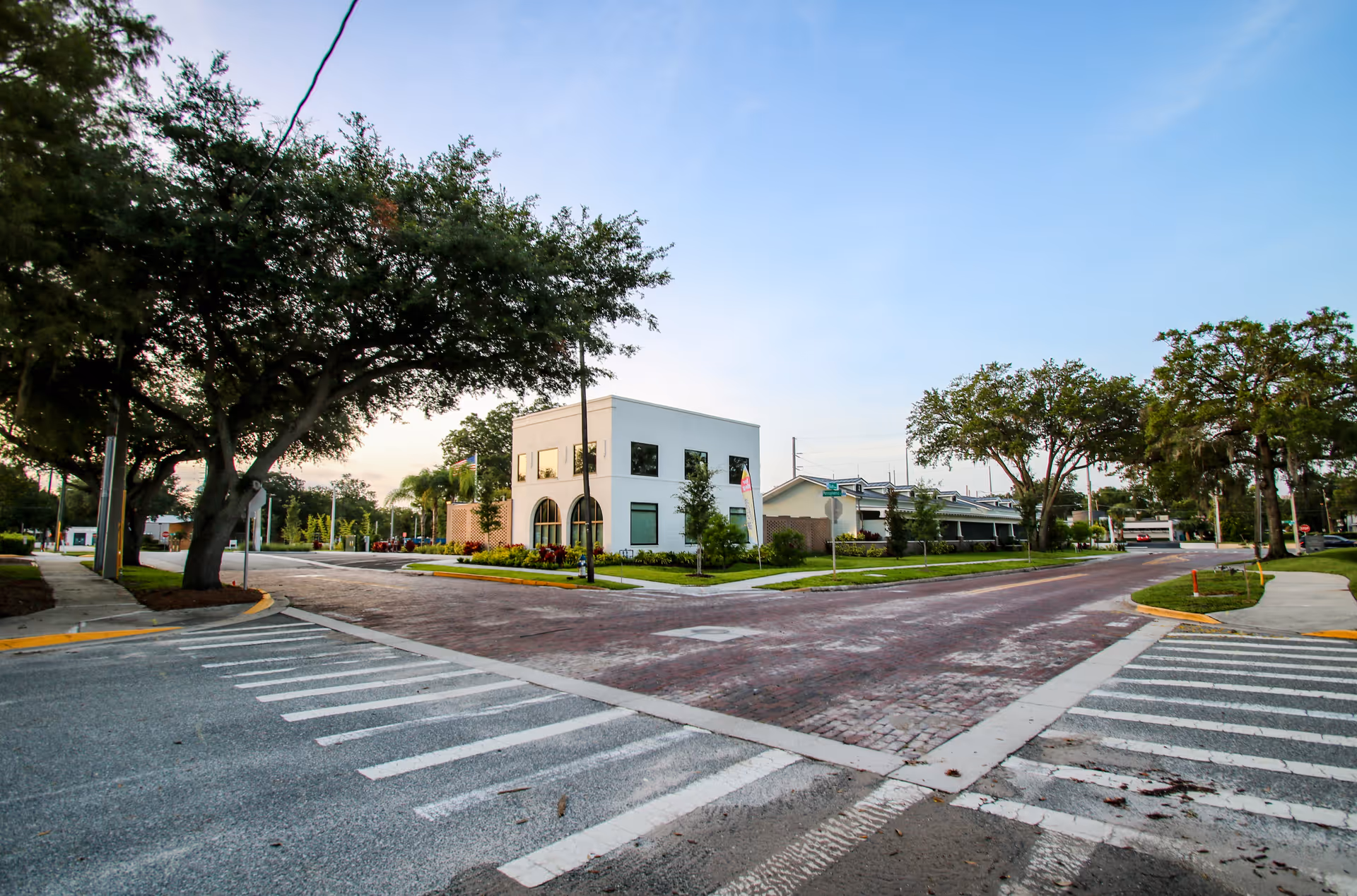 White Cornerstone Hospice building on a brick-paved street corner.