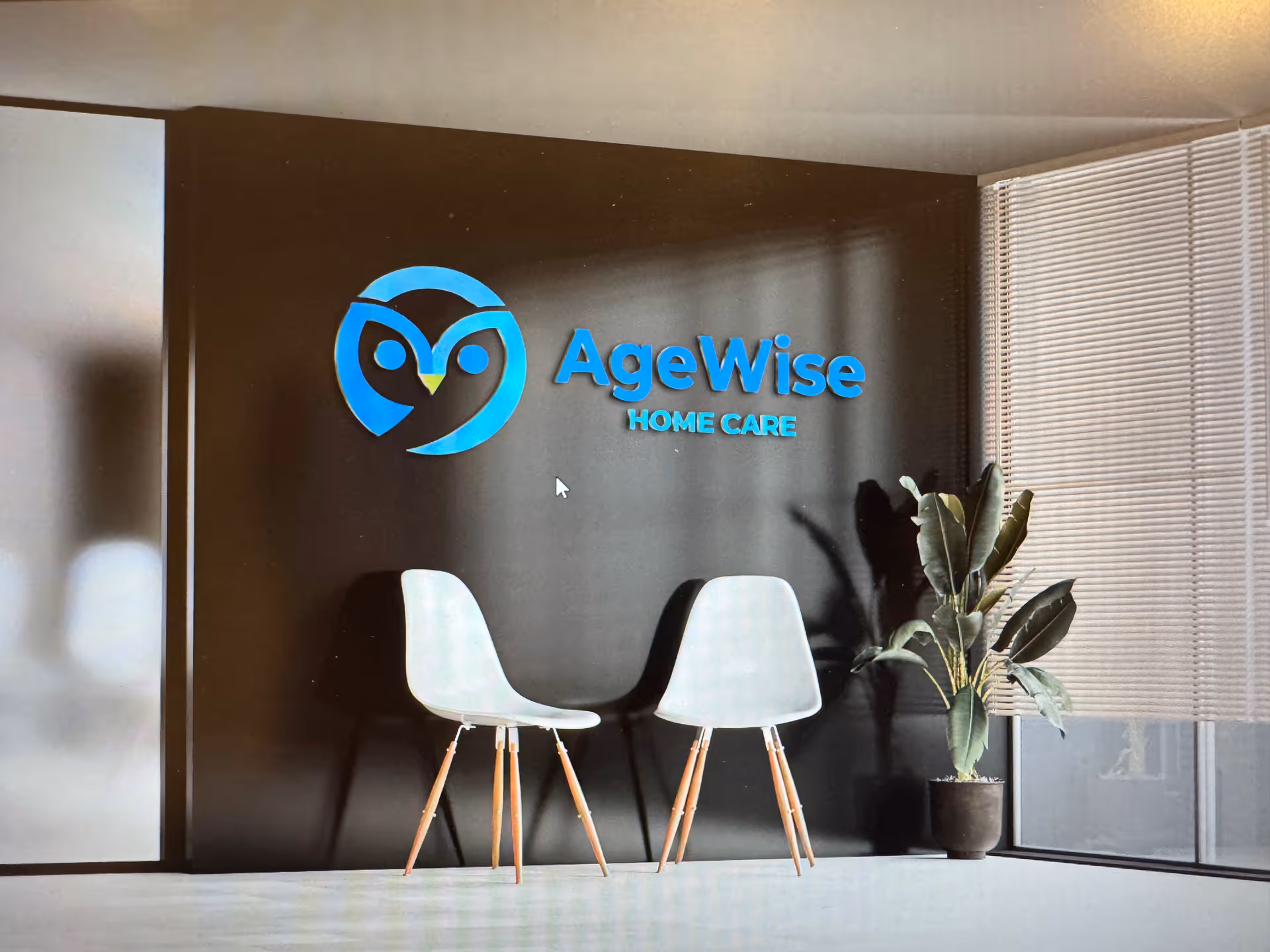 Lobby area with AgeWise Home Care logo, two white chairs, and a potted plant.