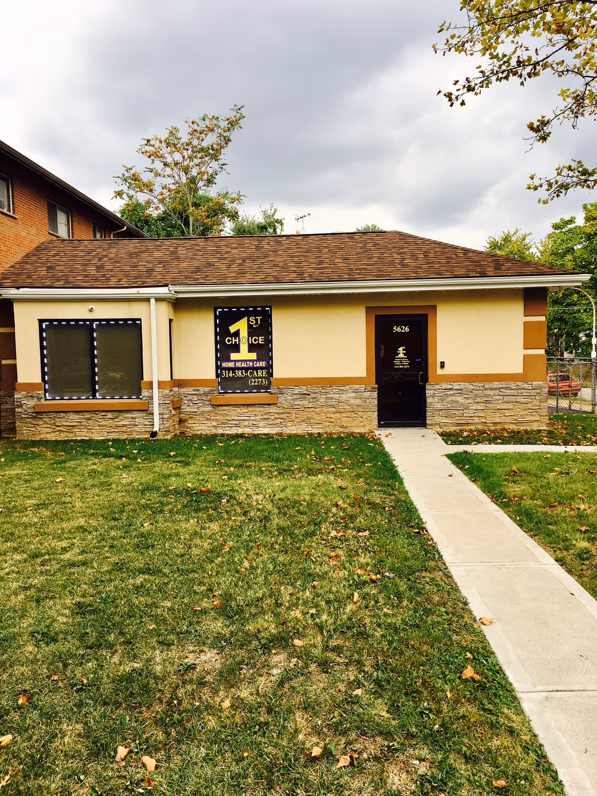 Exterior view of 1st Choice Home Health Care building with front sidewalk.