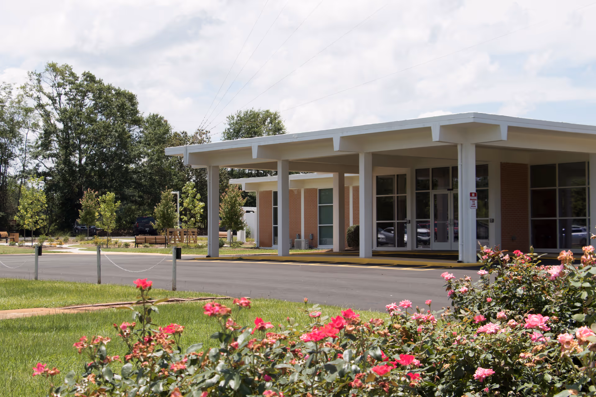 Exterior view of Magnolia Manor of Marion County with a covered entrance and rose garden.