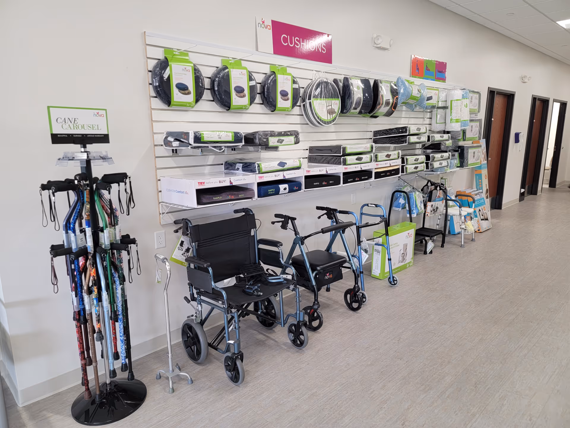 Interior corridor displaying wheelchairs, walkers, canes and medical supplies on wall shelves.