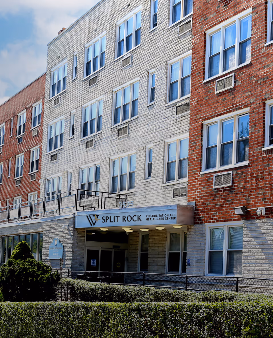 Exterior of a brick senior living building with Split Rock entrance sign.