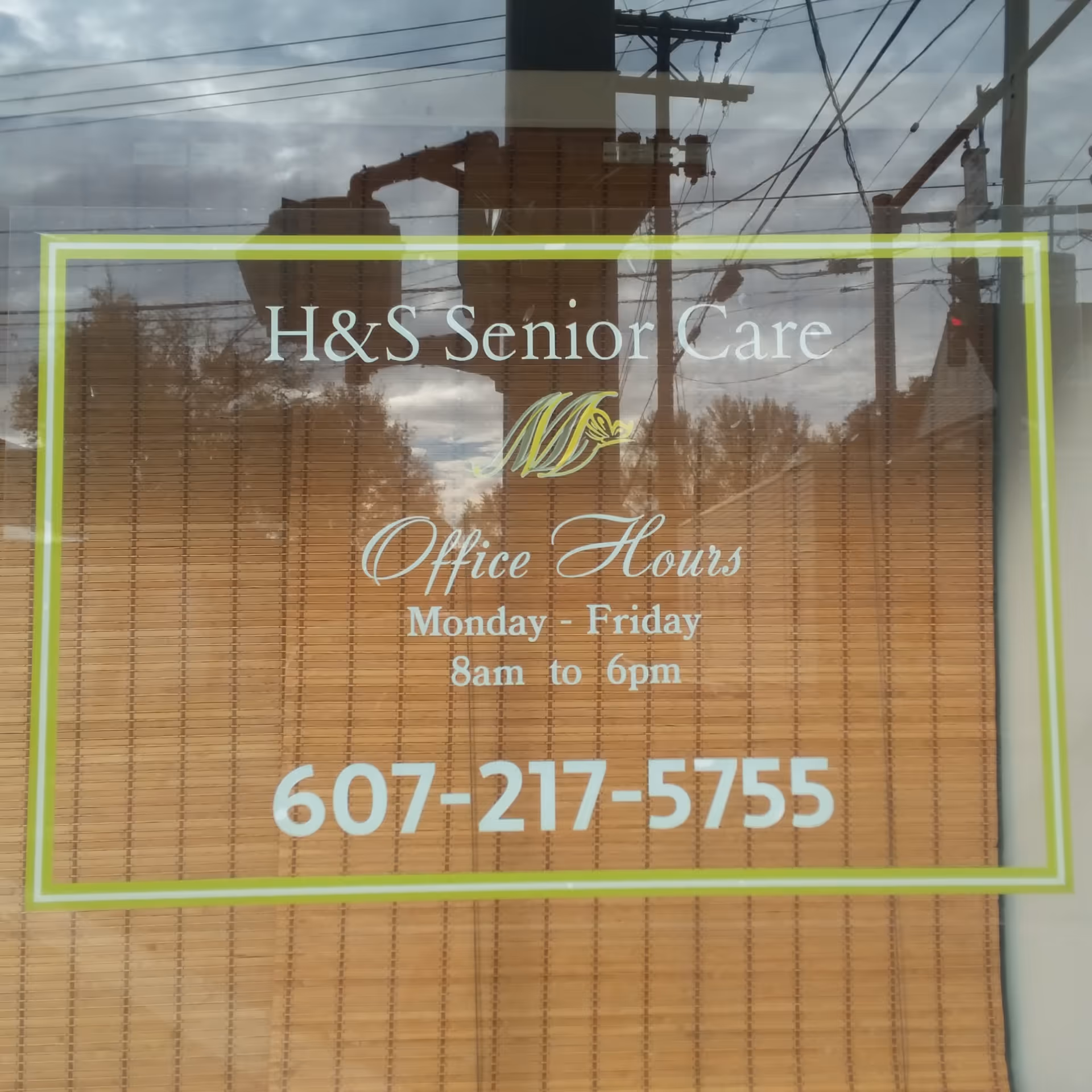 Window sign reads H&S Senior Care with office hours and phone number