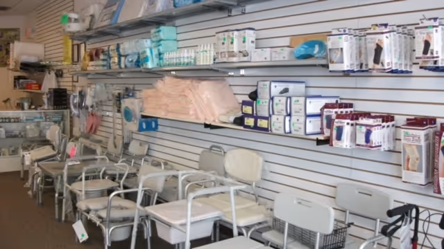 Interior view of a medical equipment store showing chairs, shelves, and supplies.