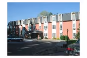 Exterior view of Eben Ezer Lutheran Care Center with parked cars in front.