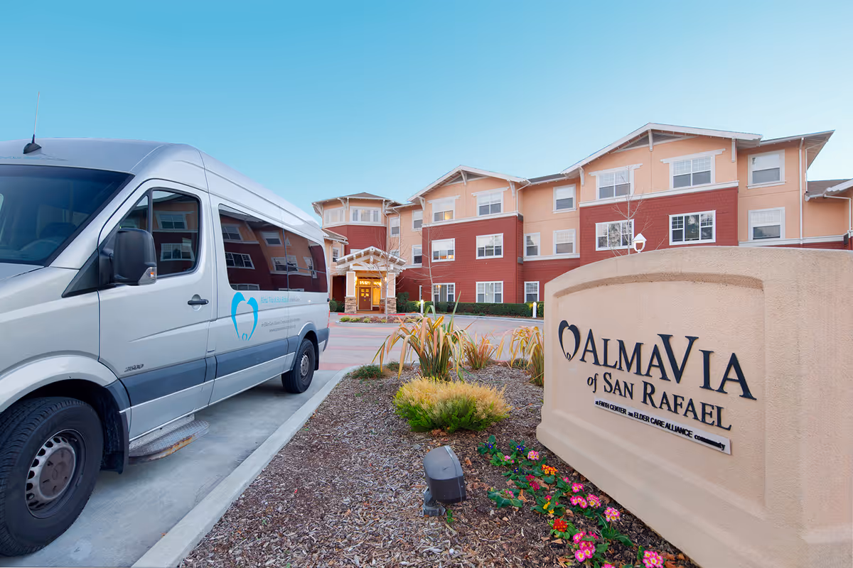 Silver van parked in front of Almavia of San Rafael senior living building.