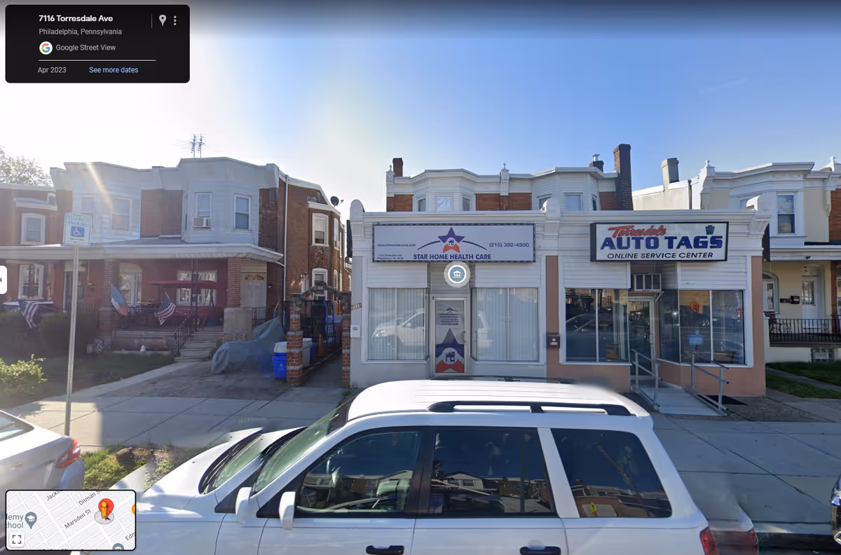 Street view of storefronts including Star Home Health Care with parked cars