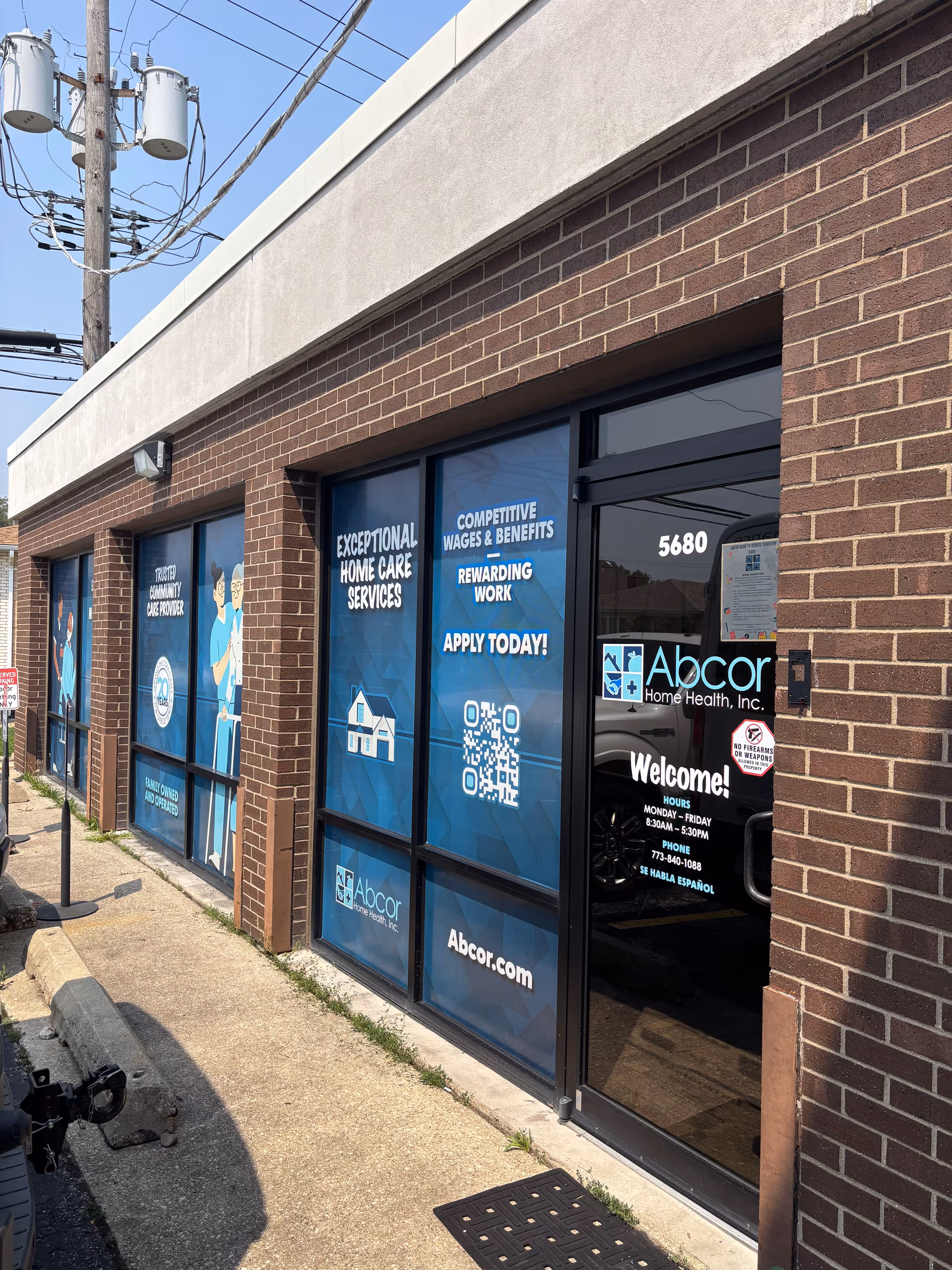 Exterior view of Abcor Home Health storefront with blue window signs and entrance.