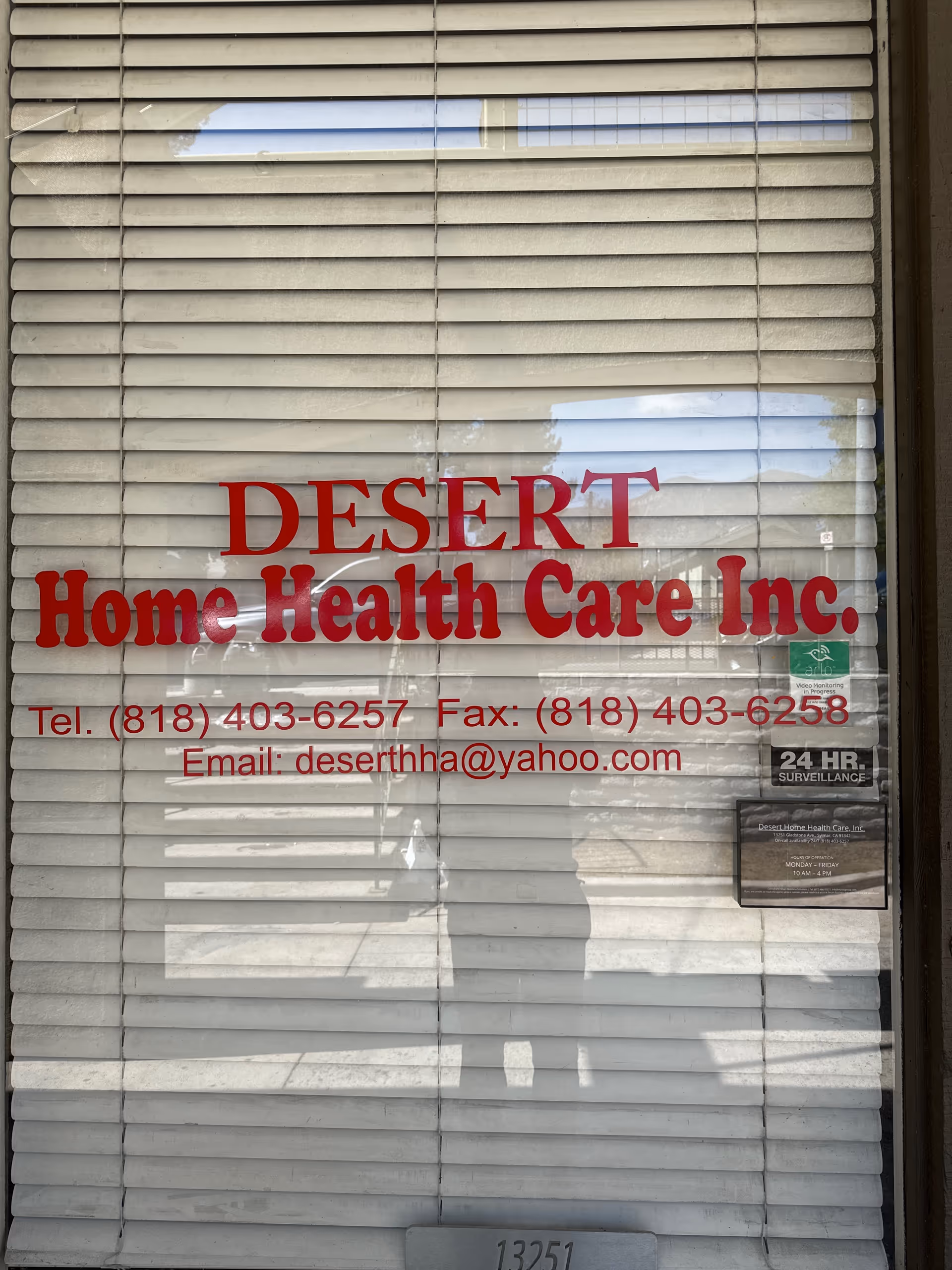 Front view of Desert Home Health Care Inc. storefront with blinds and red signage.
