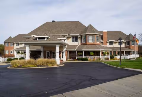 Exterior view of a senior living facility with circular driveway and welcoming entrance.