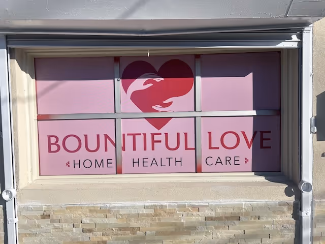 Pink storefront window with Bountiful Love Home Health Care logo and text