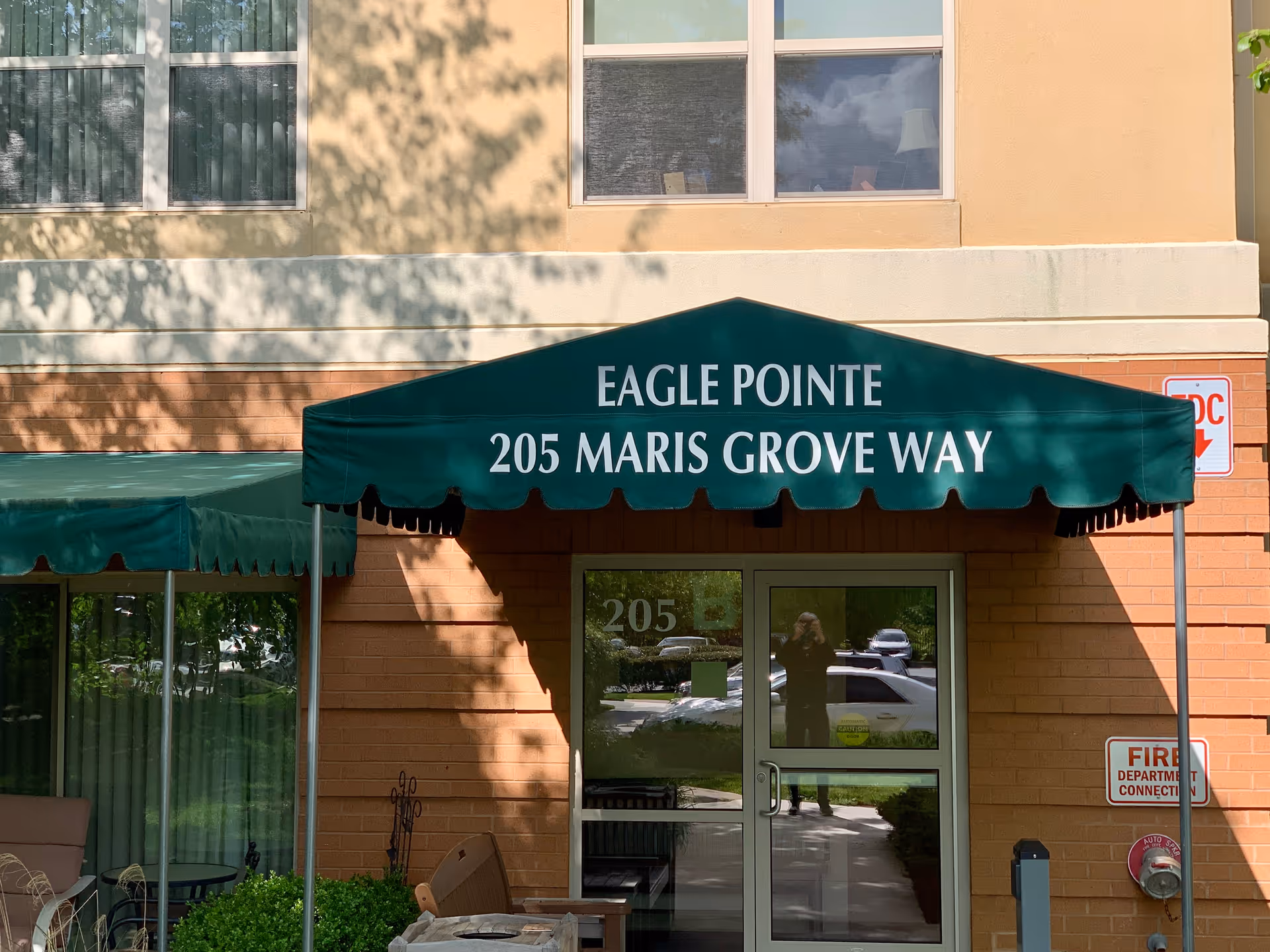 Green awning over the entrance reads Eagle Pointe, 205 Maris Grove Way.