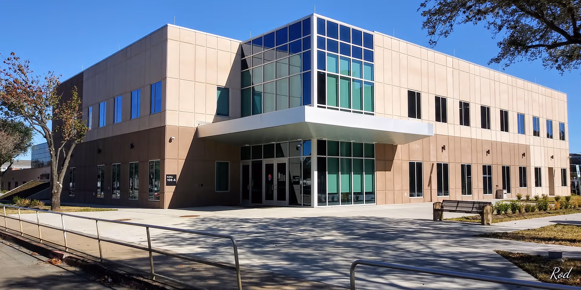 Modern two-story VA Medical Center exterior with glass entrance and walkways.