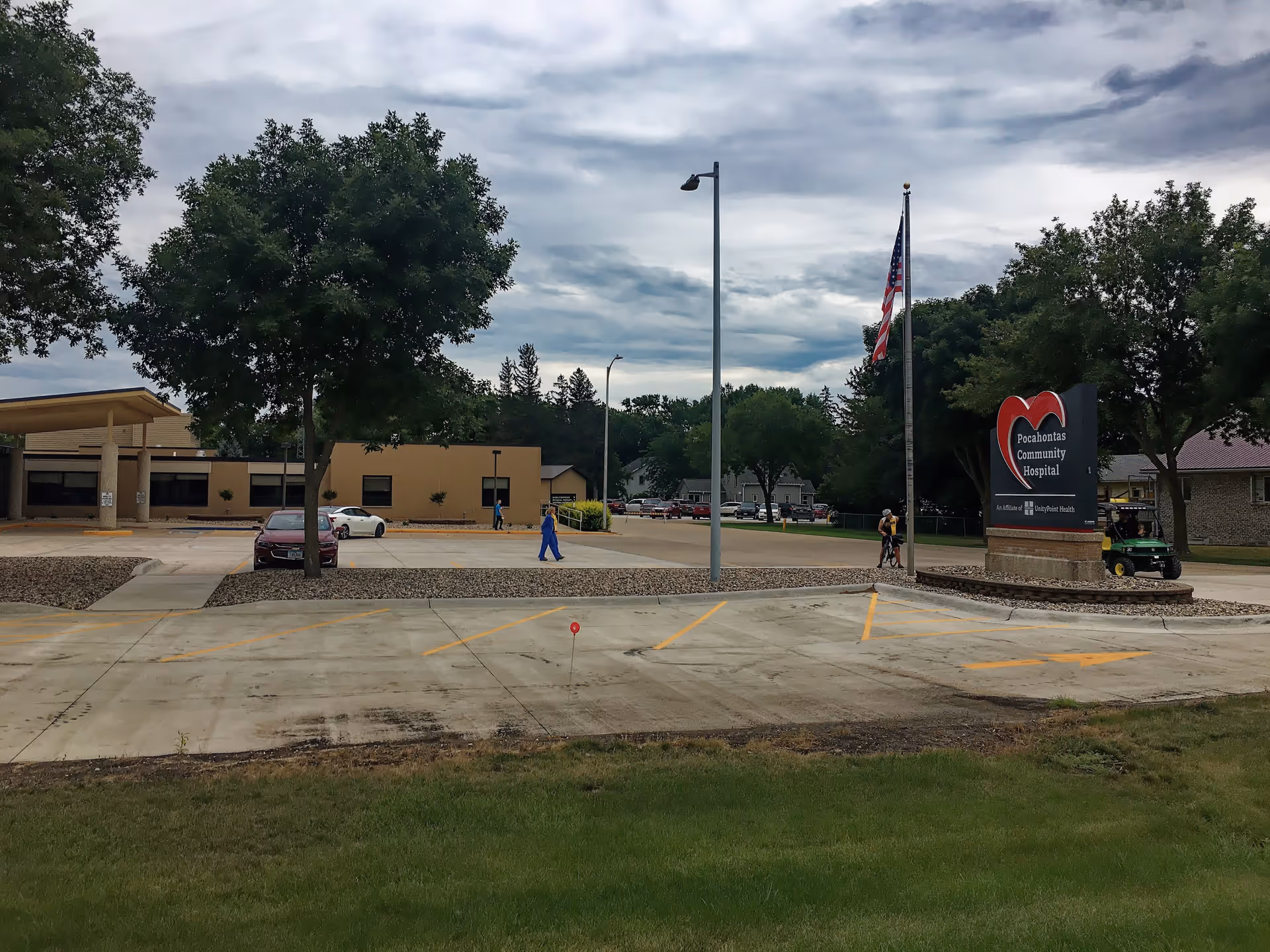 Exterior view of Pocahontas Community Hospital with sign, parking, and trees.
