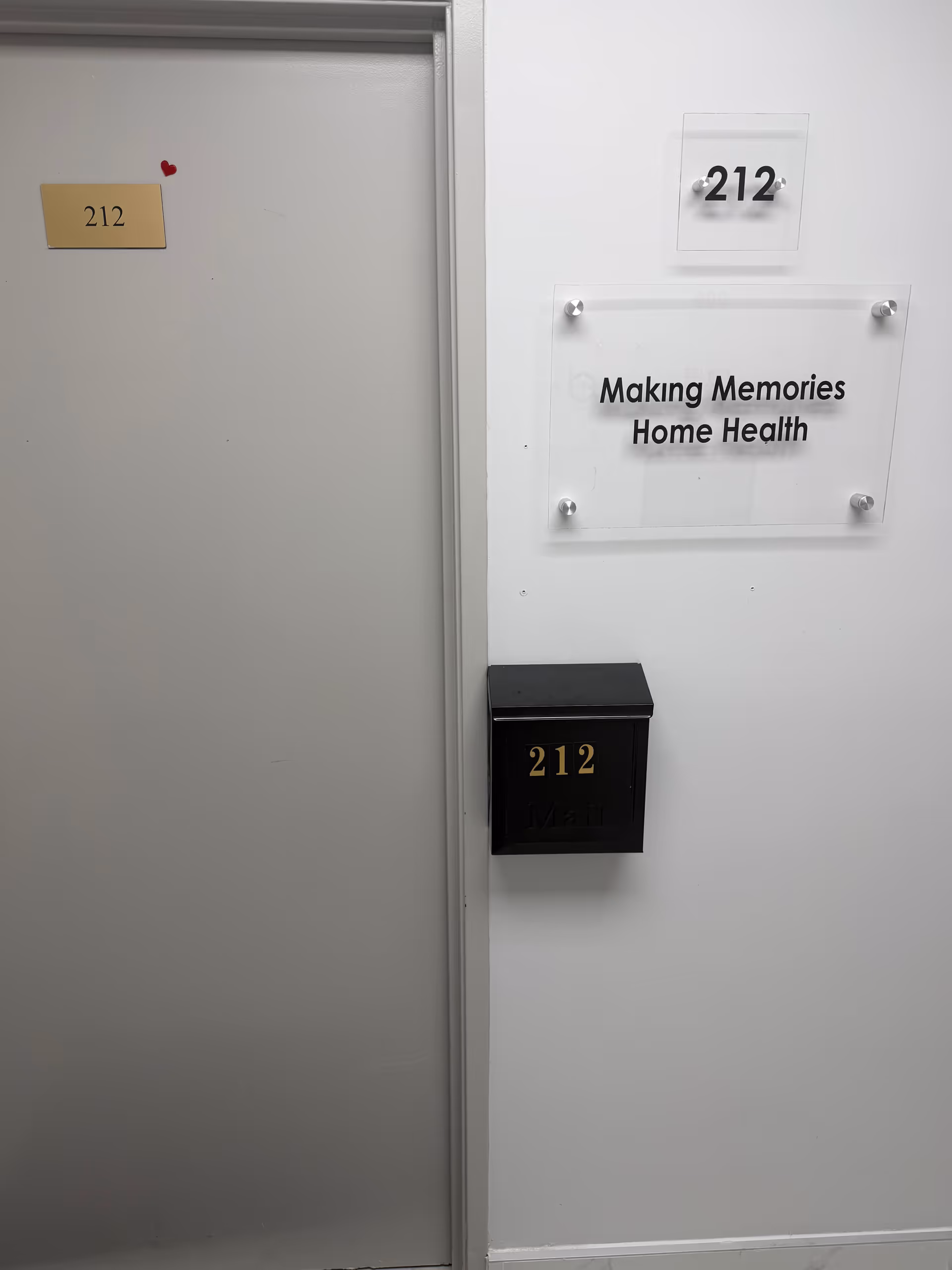 Interior hallway with door labeled 212 and a sign for Making Memories Home Health.