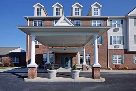Exterior of Independence Village of Fishers South featuring brick building and covered entrance.