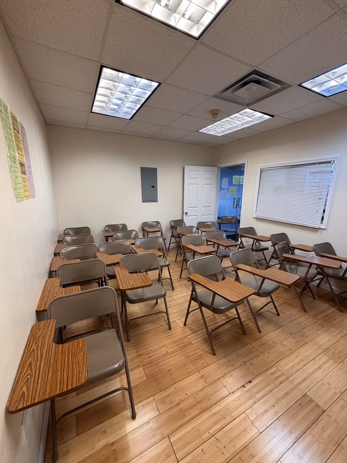Interior classroom-style room with rows of desks and chairs.