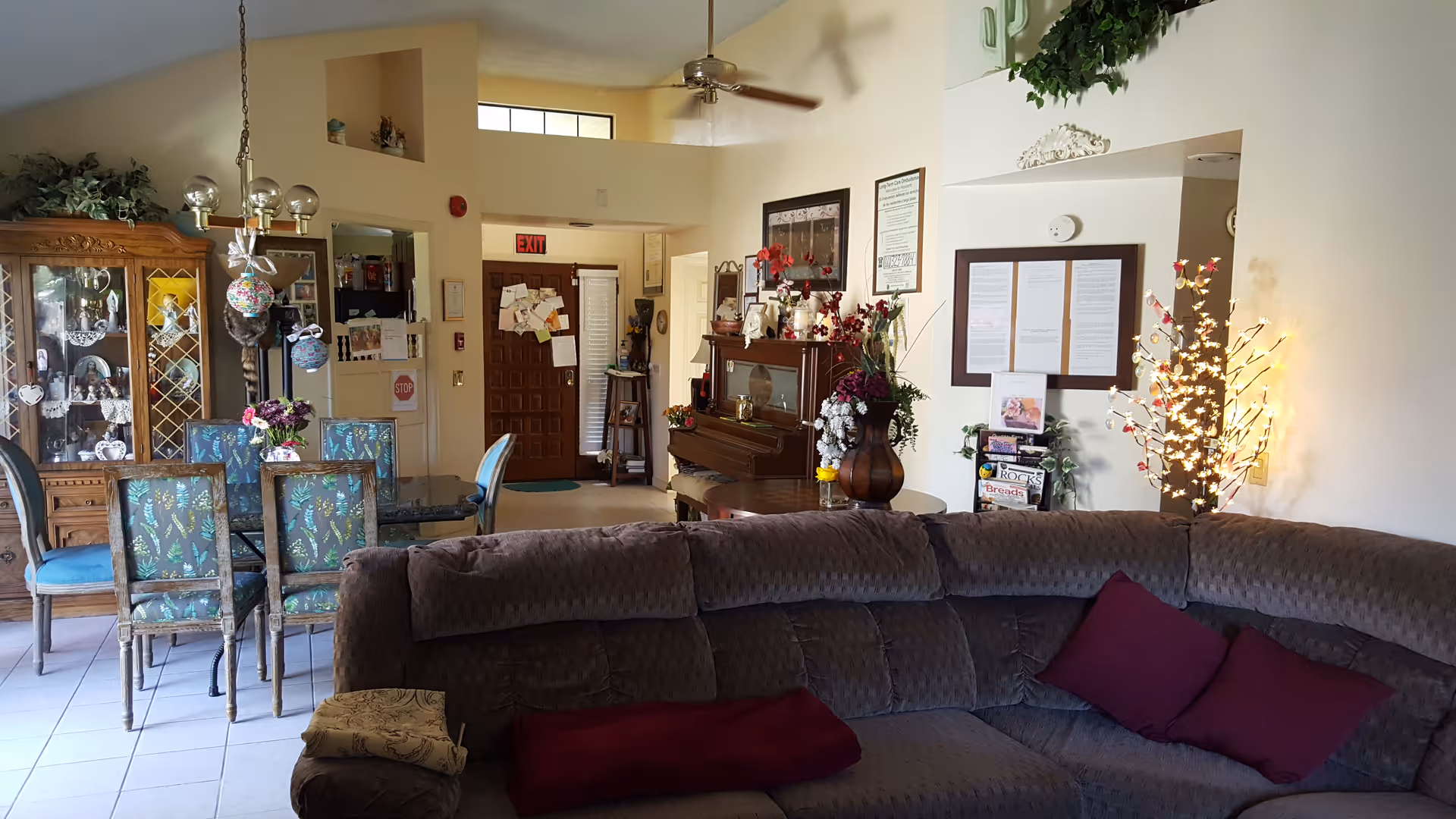 Spacious common living area with a large sectional sofa, dining table, and decorative furnishings.