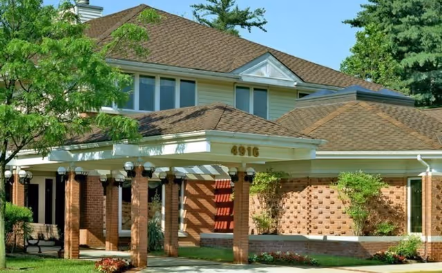 Exterior view of Malta House South building with brick columns and landscaped entrance.