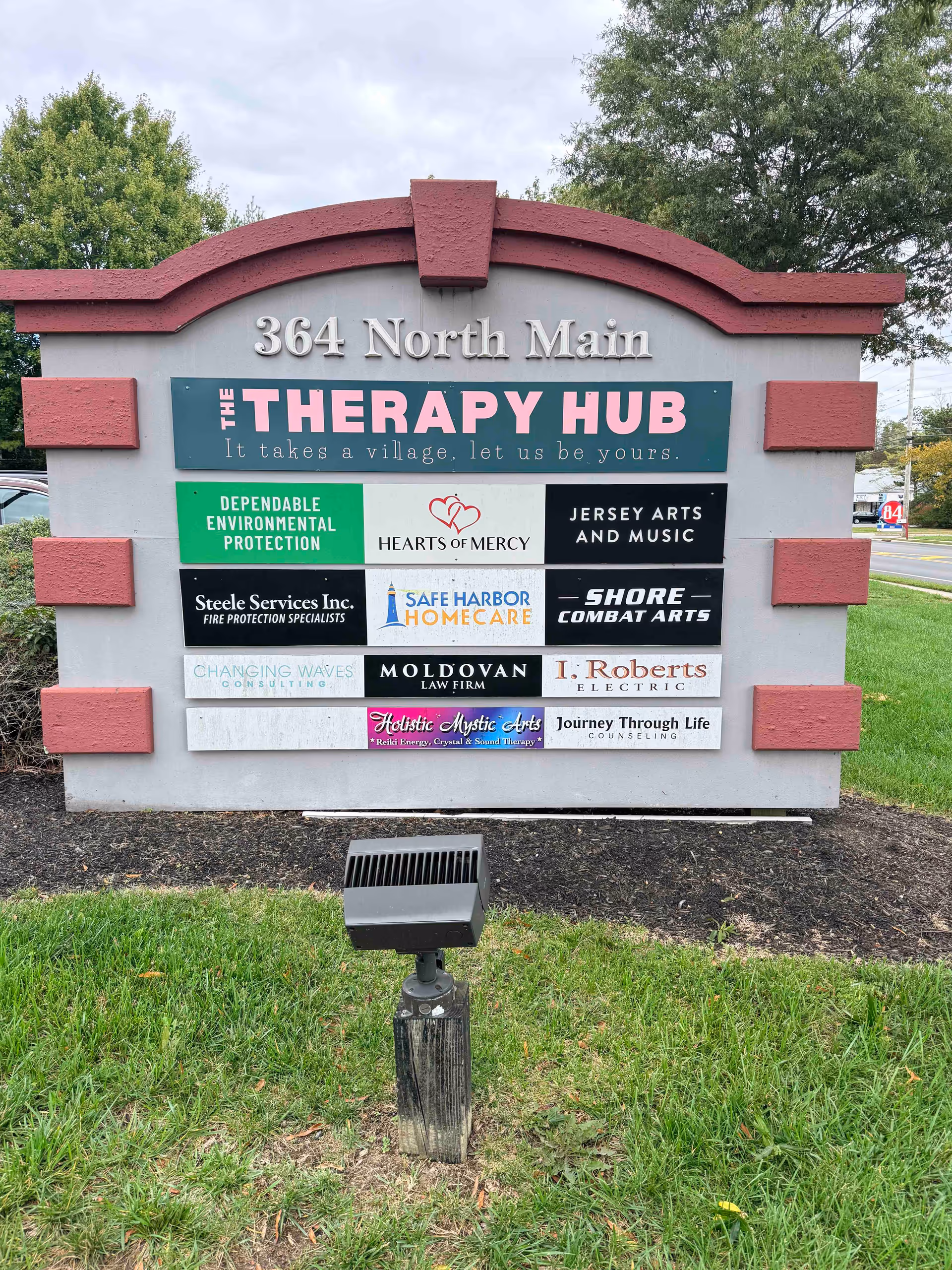 Front signboard with Therapy Hub plaques at 364 North Main.