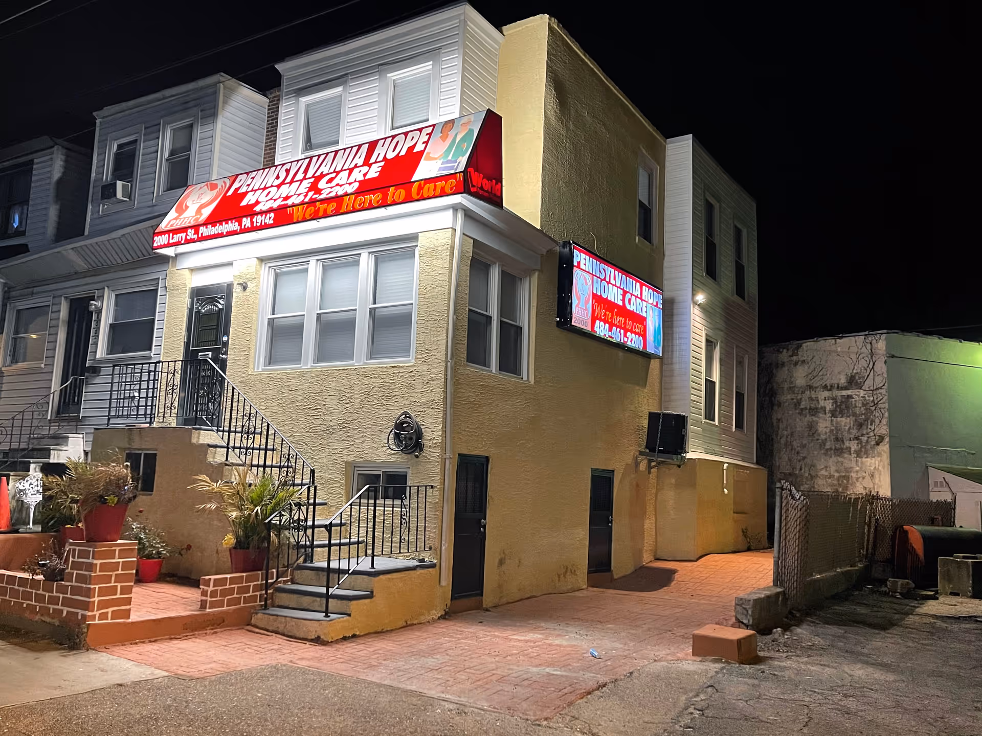 Night exterior of Pennsylvania Hope Home Care building with sign and stairs