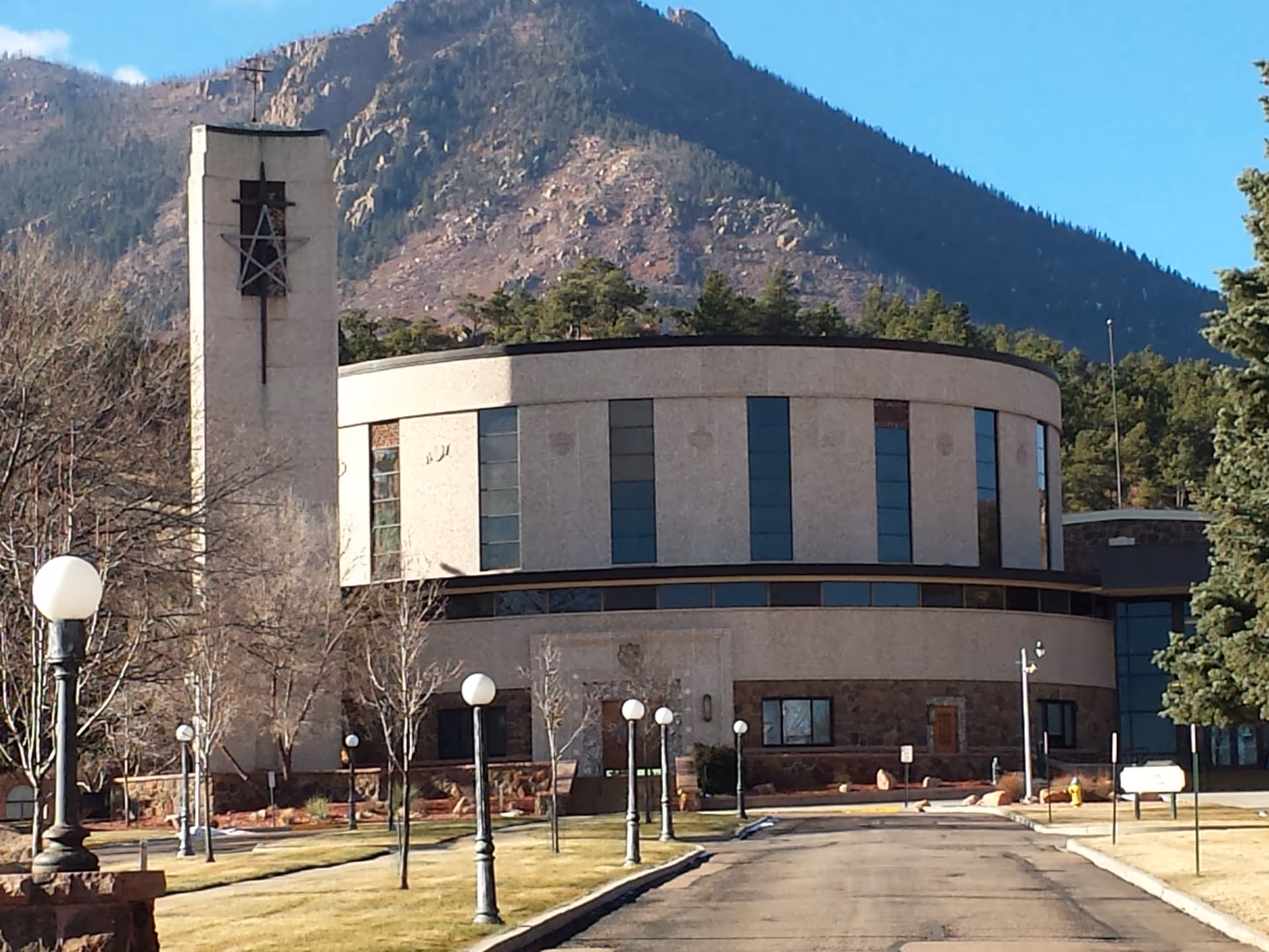 Exterior view of Mount St Francis Nursing Center with a round building and tall tower.
