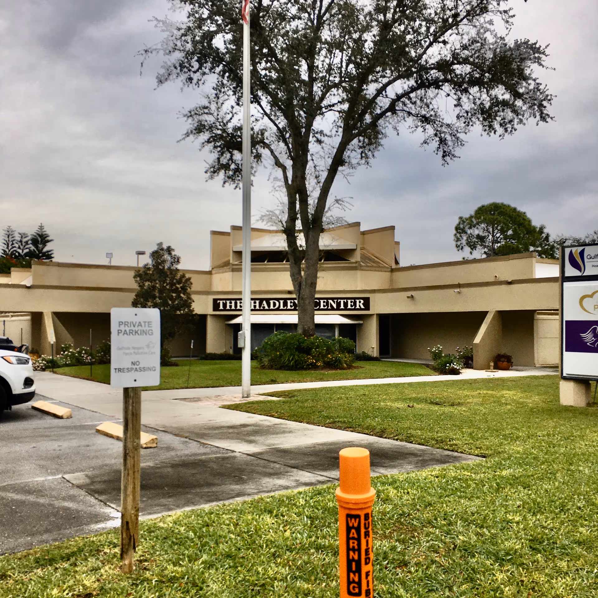 Exterior view of The Hadley Center building with sign, parking, and surrounding lawn.