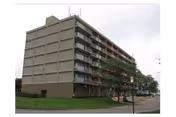 Exterior view of a multi-story senior living facility with balconies.