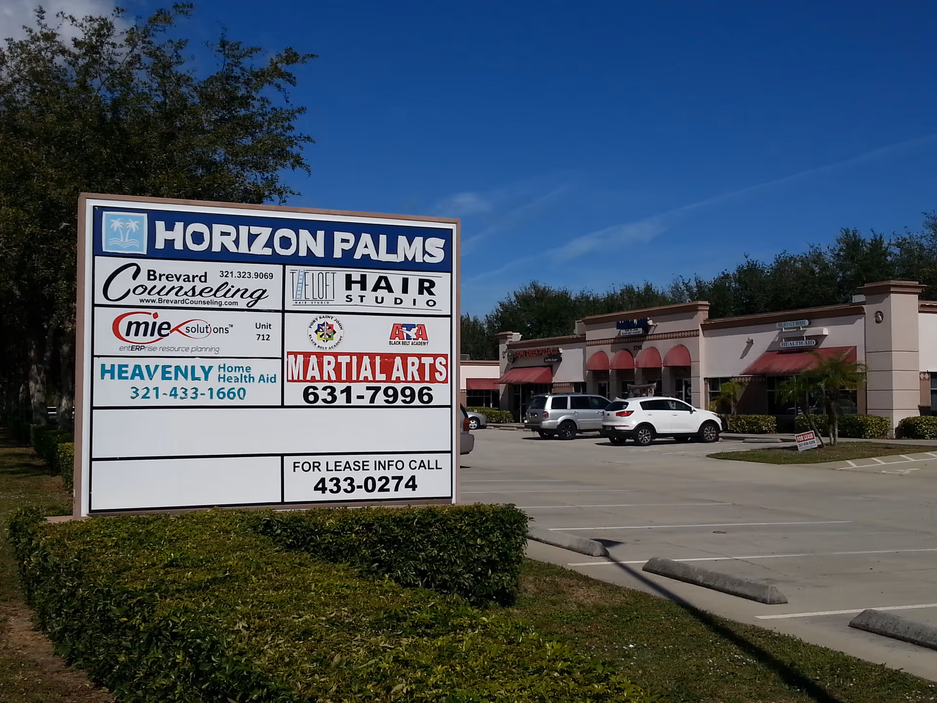 Exterior strip mall scene featuring a Horizon Palms sign and Heavenly Home Health Aid board