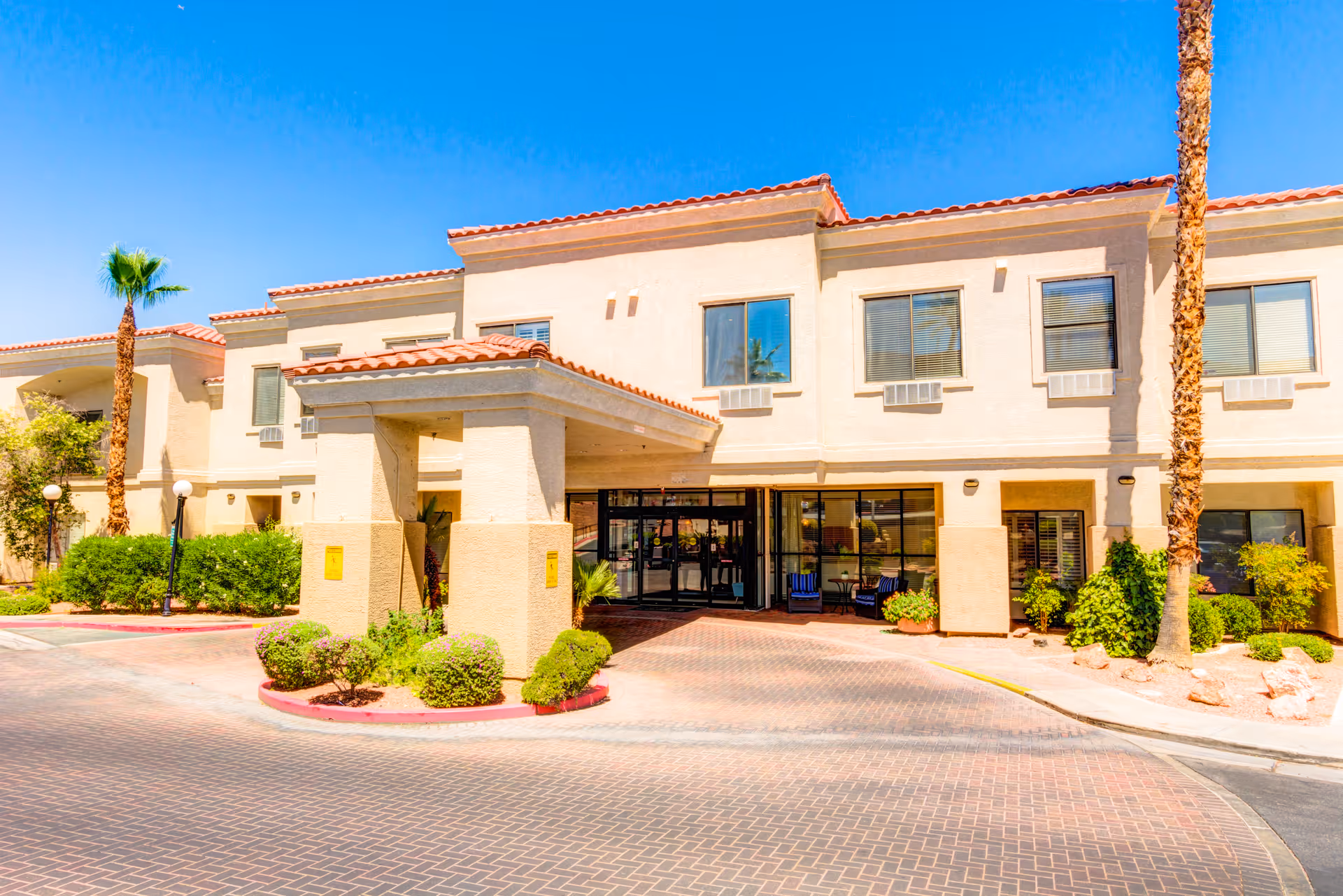 Exterior view of Escalante at the Lakes senior living facility with a landscaped entrance.