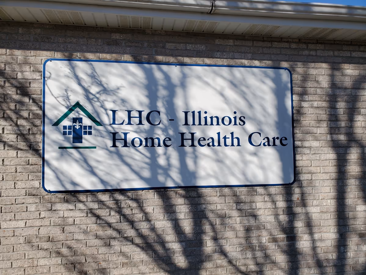 Exterior brick wall with a large sign reading LHC - Illinois Home Health Care