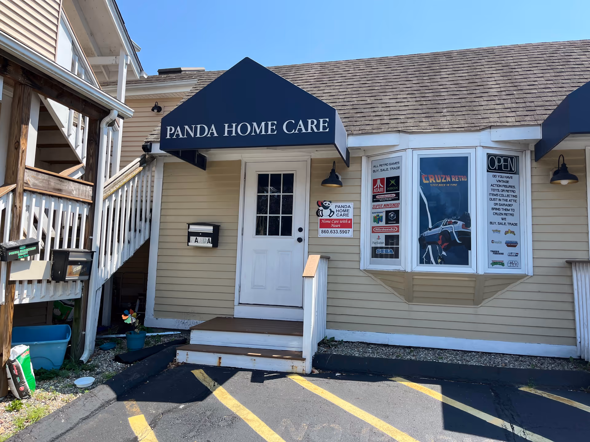 Exterior view of Panda Home Care storefront with sign, posters, and entrance steps.