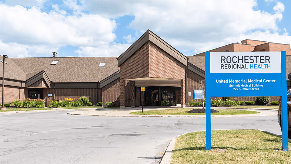 Brick medical building with blue Rochester Regional Health sign by the entrance.