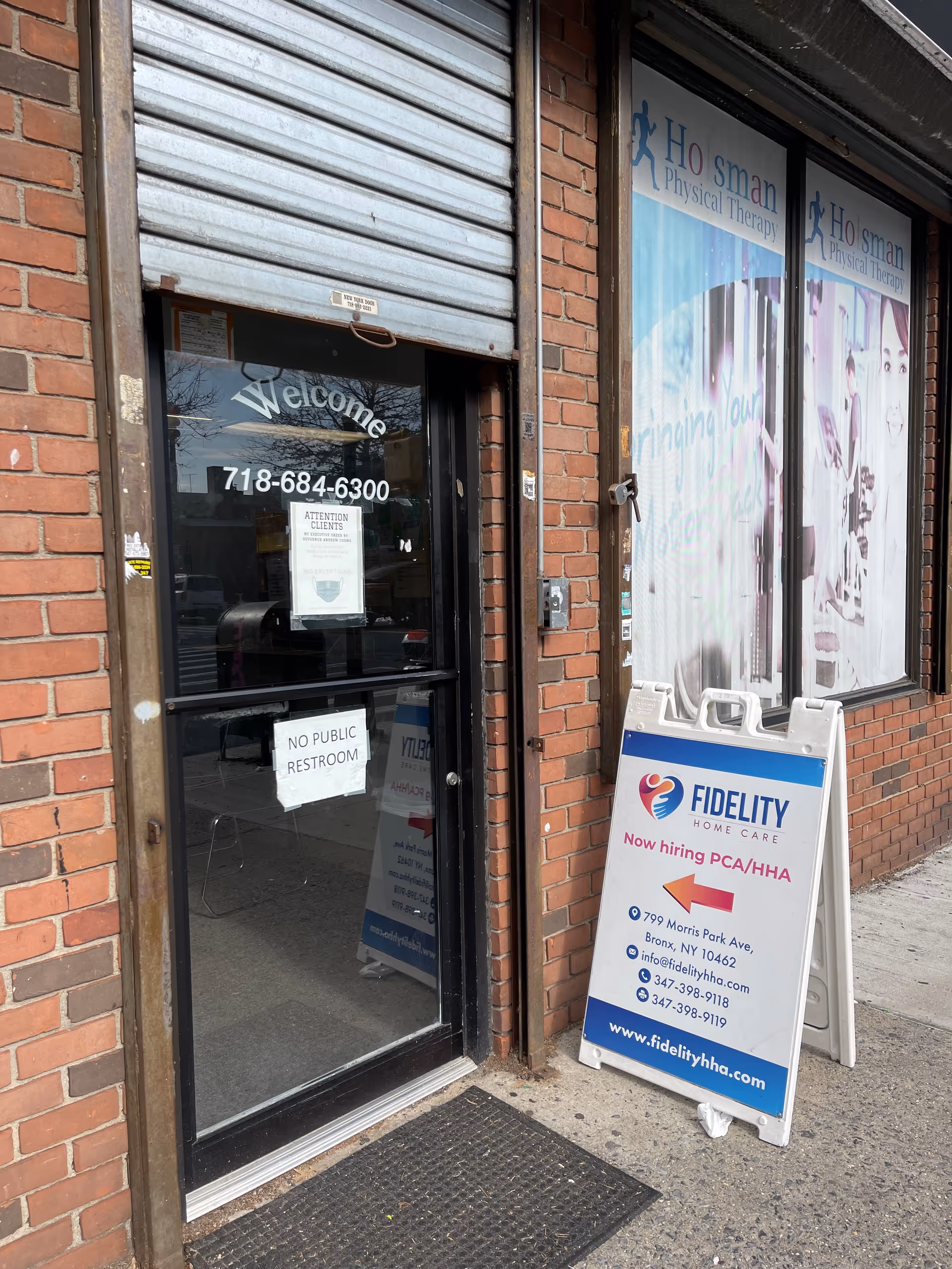 Brick storefront with Fidelity Home Care sign and recruitment board outside.