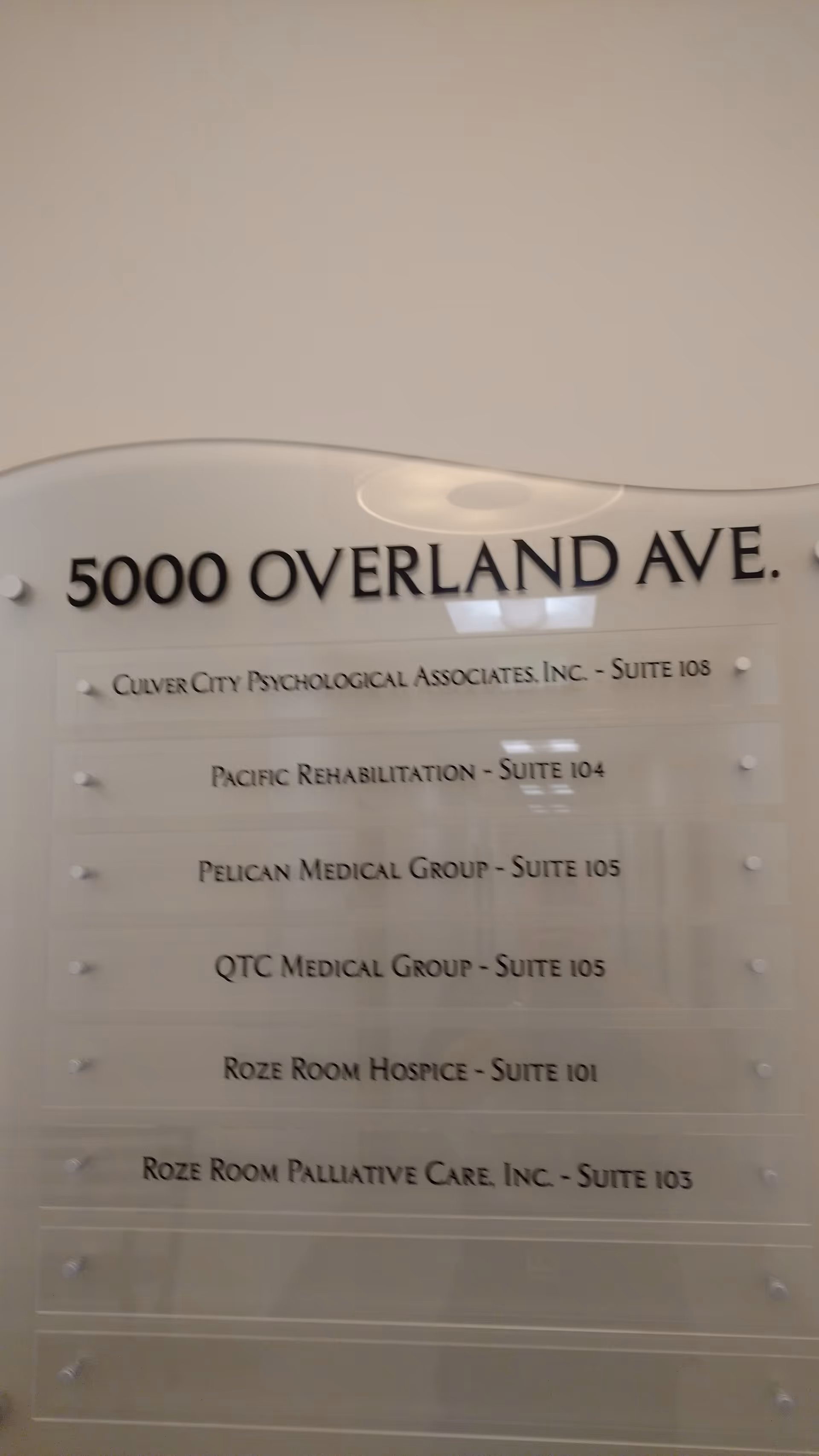 Interior wall directory sign listing multiple suites and medical offices at 5000 Overland Ave.